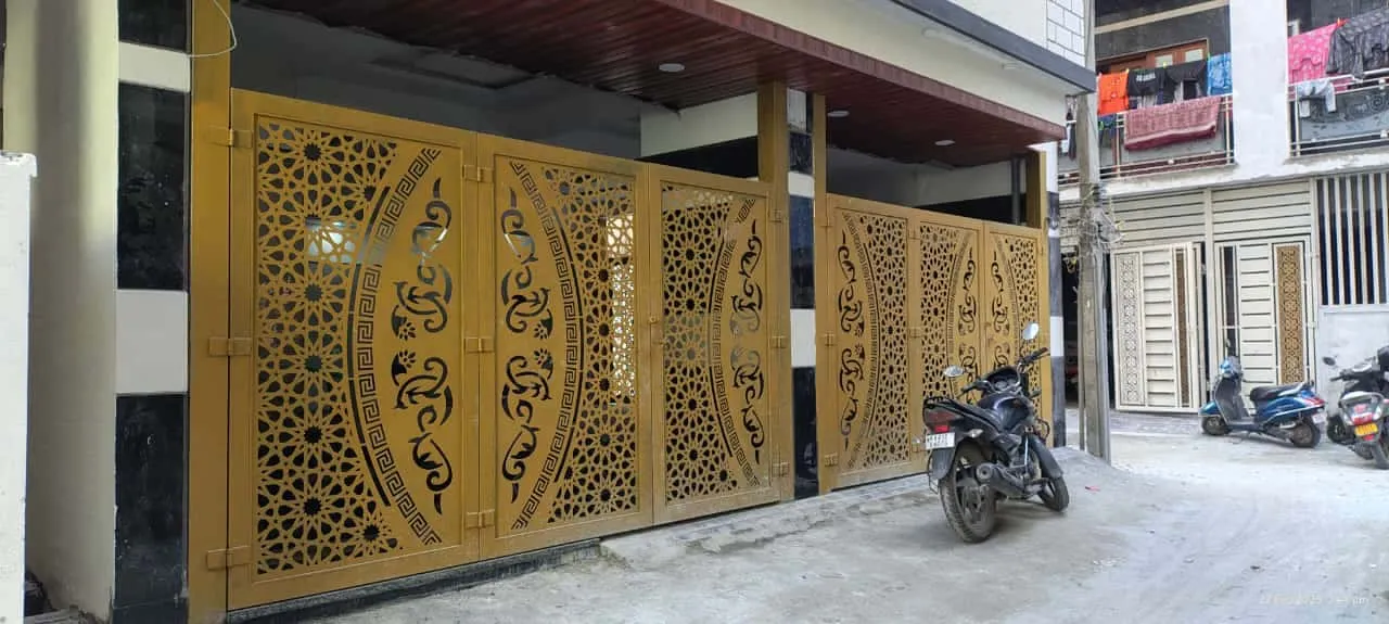 CNC laser cut mild steel gate with intricate Arabic geometric pattern in gold powder coat finish for a residential property in Bangalore